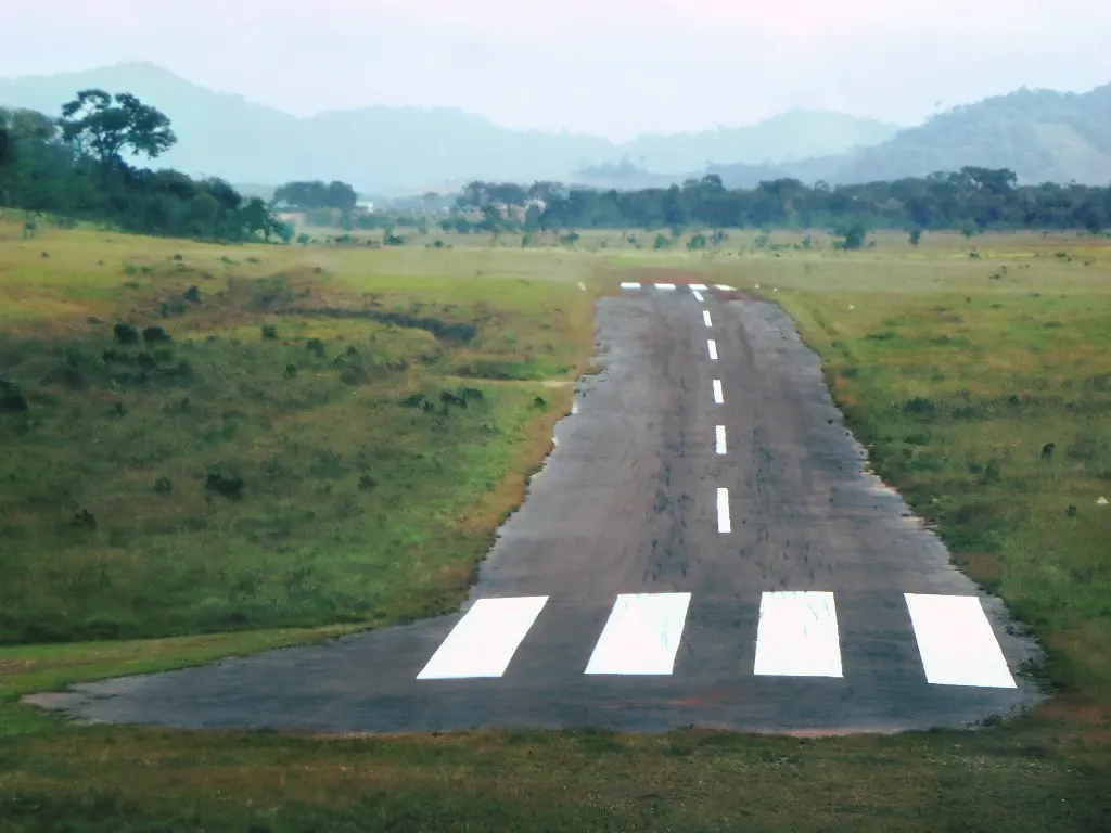 A short paved airstrip at Annai running towards forested hills