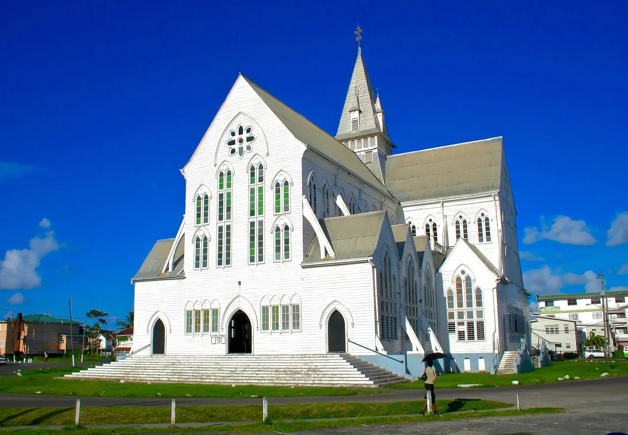 St George's Cathedral in Georgetown, a tall white wooden Gothic Revival church under a blue sky